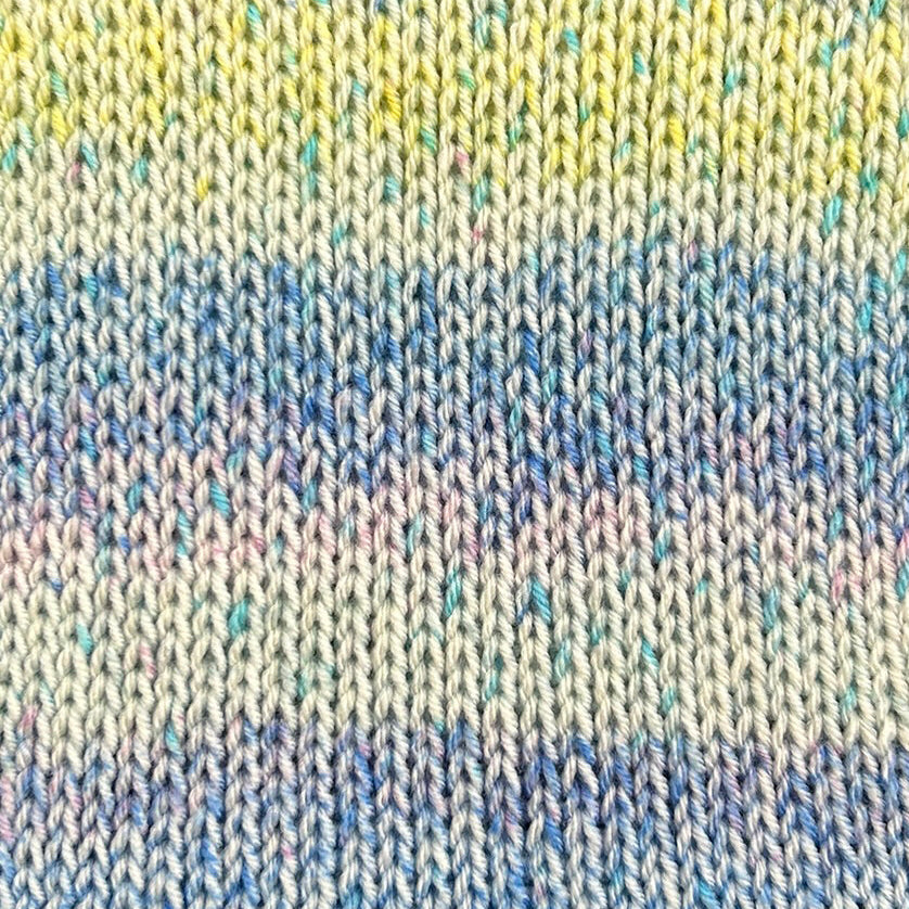 Close up of a yellow, blue and light blue knitted fabric