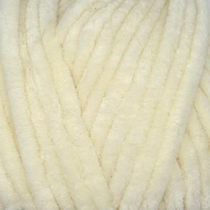 A close-up texture shot of thick, fluffy cream-colored yarn strands.