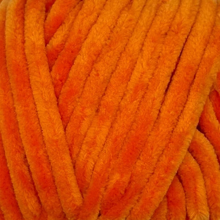 Close-up of bright orange fuzzy chenille pipe cleaners bundled together, showing the soft textured strands.