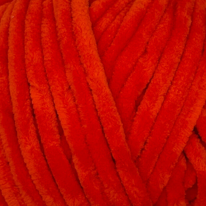 A close-up of bright red fuzzy chenille yarn strands, showing the soft textured surface.