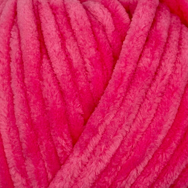 A close-up of bright hot pink fuzzy chenille yarn strands, showing the soft textured surface.