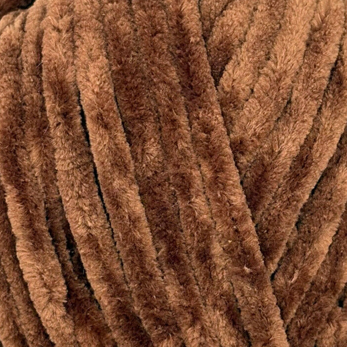 A close-up of thick, plush brown yarn strands, showing the soft, fuzzy texture of the material.