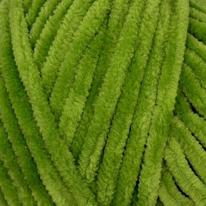 Close-up of bright lime green fuzzy chenille pipe cleaners or yarn strands filling the frame.