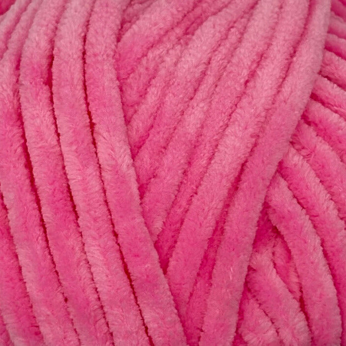 A close-up of bright pink fuzzy chenille yarn strands, showing the soft textured surface.
