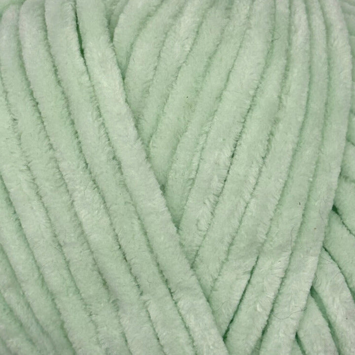 A close-up of mint green fuzzy chenille yarn strands, showing the soft plush texture and thick cord-like thickness.
