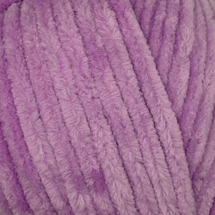 A close-up of fluffy lavender purple yarn strands, showing the soft textured surface of the material.
