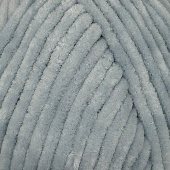 A close-up of light blue plush chenille yarn, showing the soft, fuzzy texture and ribbed pattern of the strands.