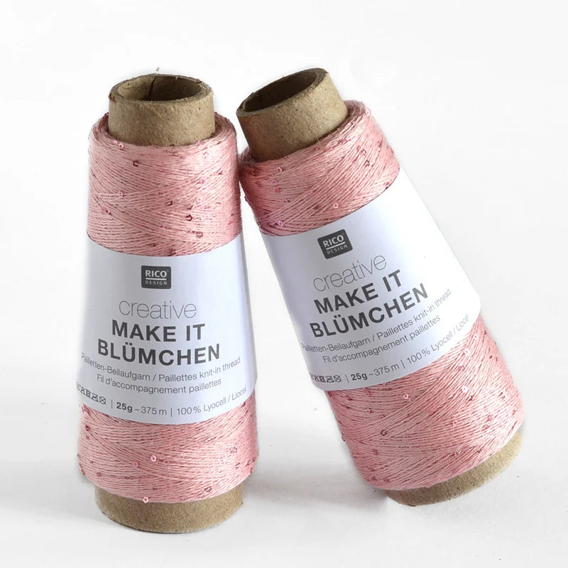 Two spools of Rico Design Creative Make It Bümchen thread in a dusty pink color with small sequins, standing on a white background.
