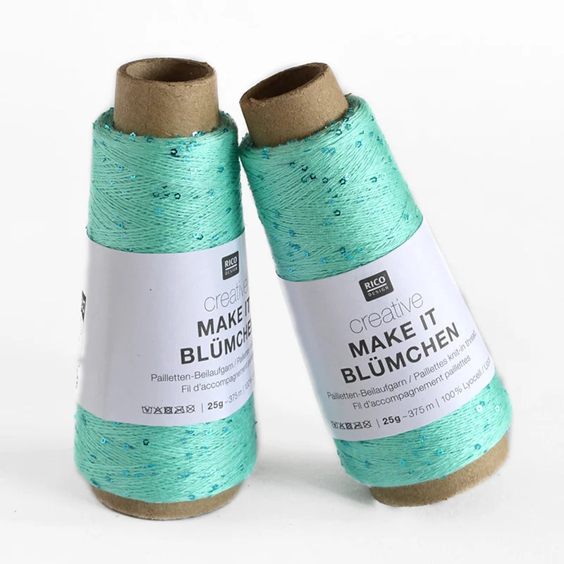 Two spools of Creative Make It Blümchen thread in a light mint green color with subtle sequins, standing on a white background.