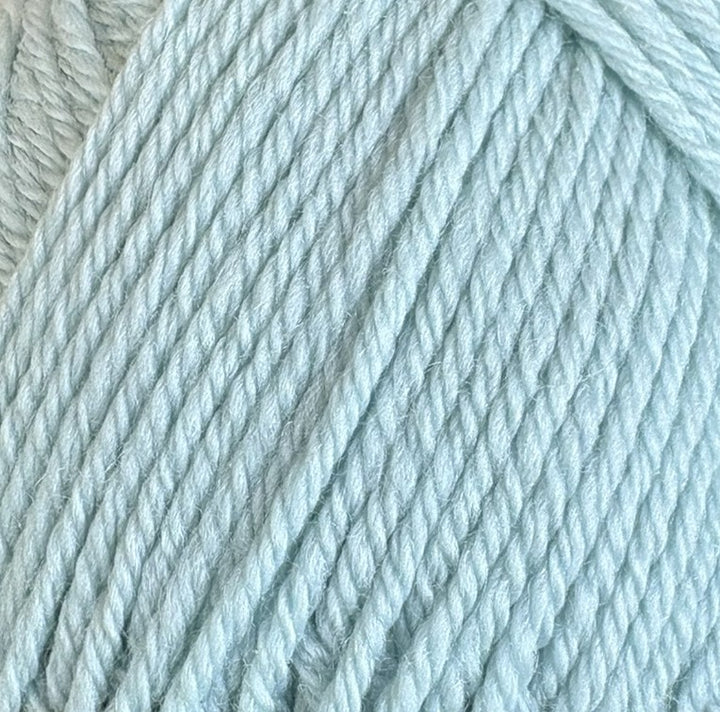 A close-up of pale icy blue plied yarn, showing the twisted texture of the fibers.