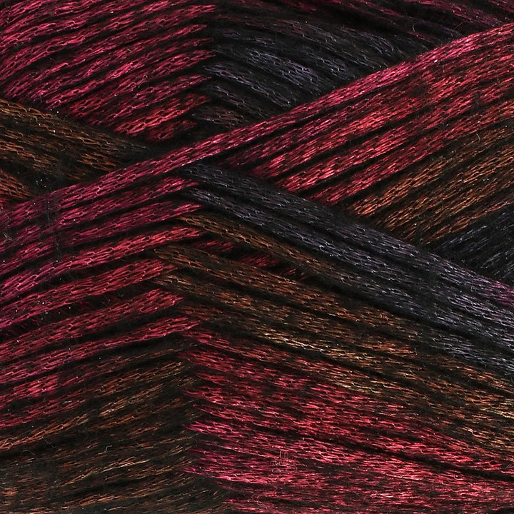 Close-up of multicolored yarn with red, black, and brown hues.