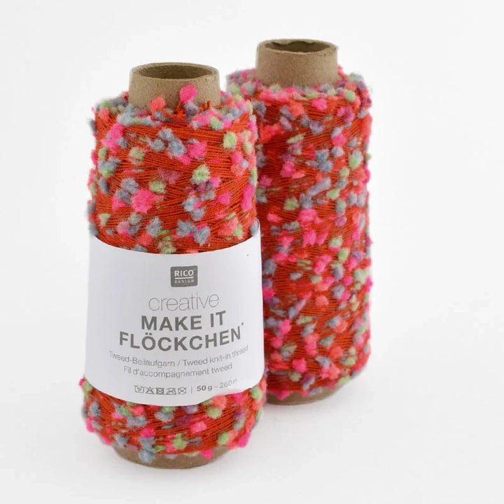 Two spools of Rico Design Creative Make It Flockchen twine, featuring a vibrant orange-red base yarn with pink, green, and blue fluffy accents, on a white background.