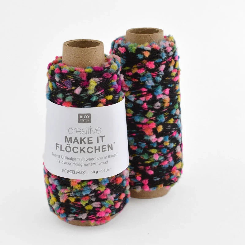 Two spools of RICO DESIGN creative Make It Flockchen tweed yarn in a multicolor black base with pink, blue, yellow, and green flecks, on a white background.