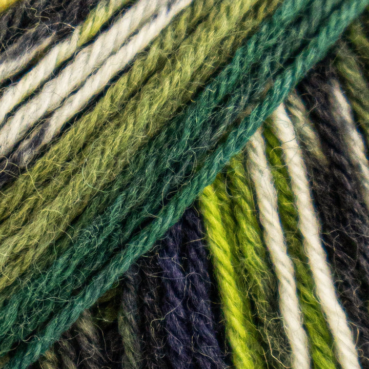 Close-up of colorful yarn strands in green, white, and purple.