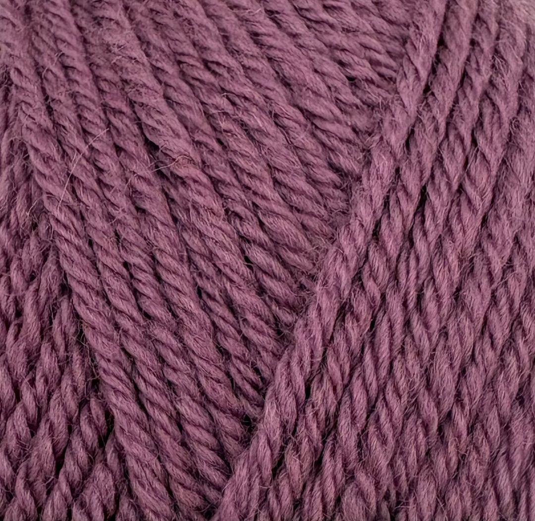 A close-up of twisted yarn strands in a dusty mauve-purple color, filling the entire frame.