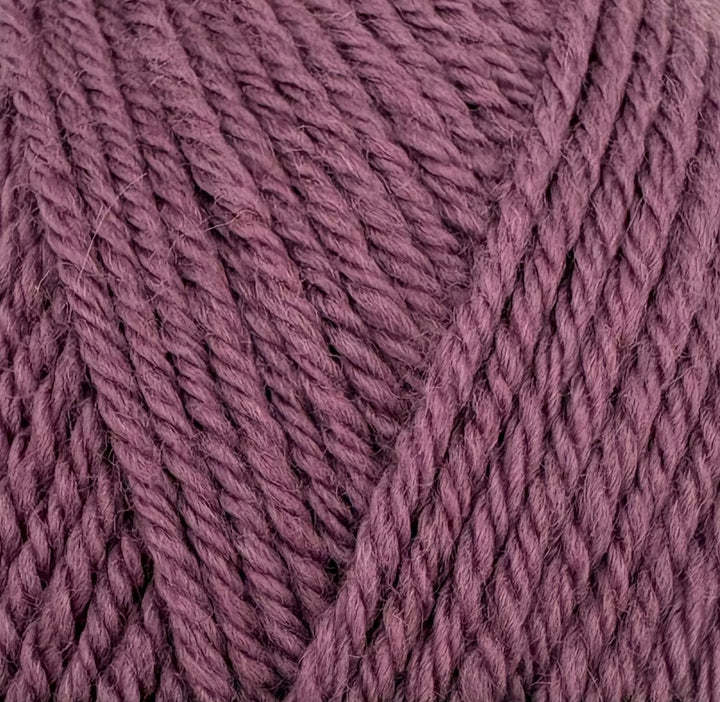 A close-up of twisted yarn strands in a dusty mauve-purple color, filling the entire frame.