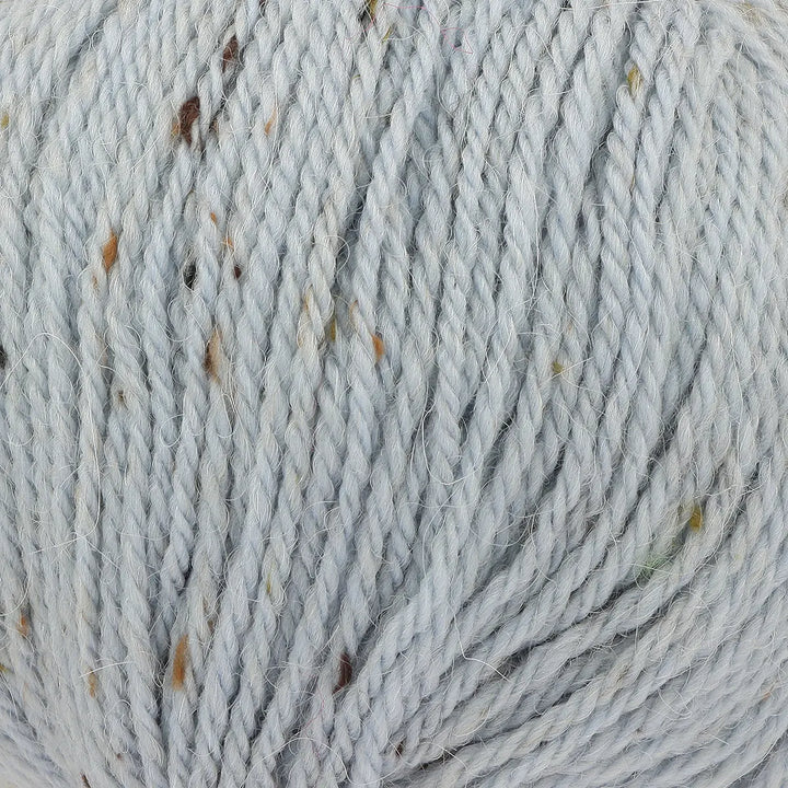 Close-up of gray yarn with specks of brown and black.