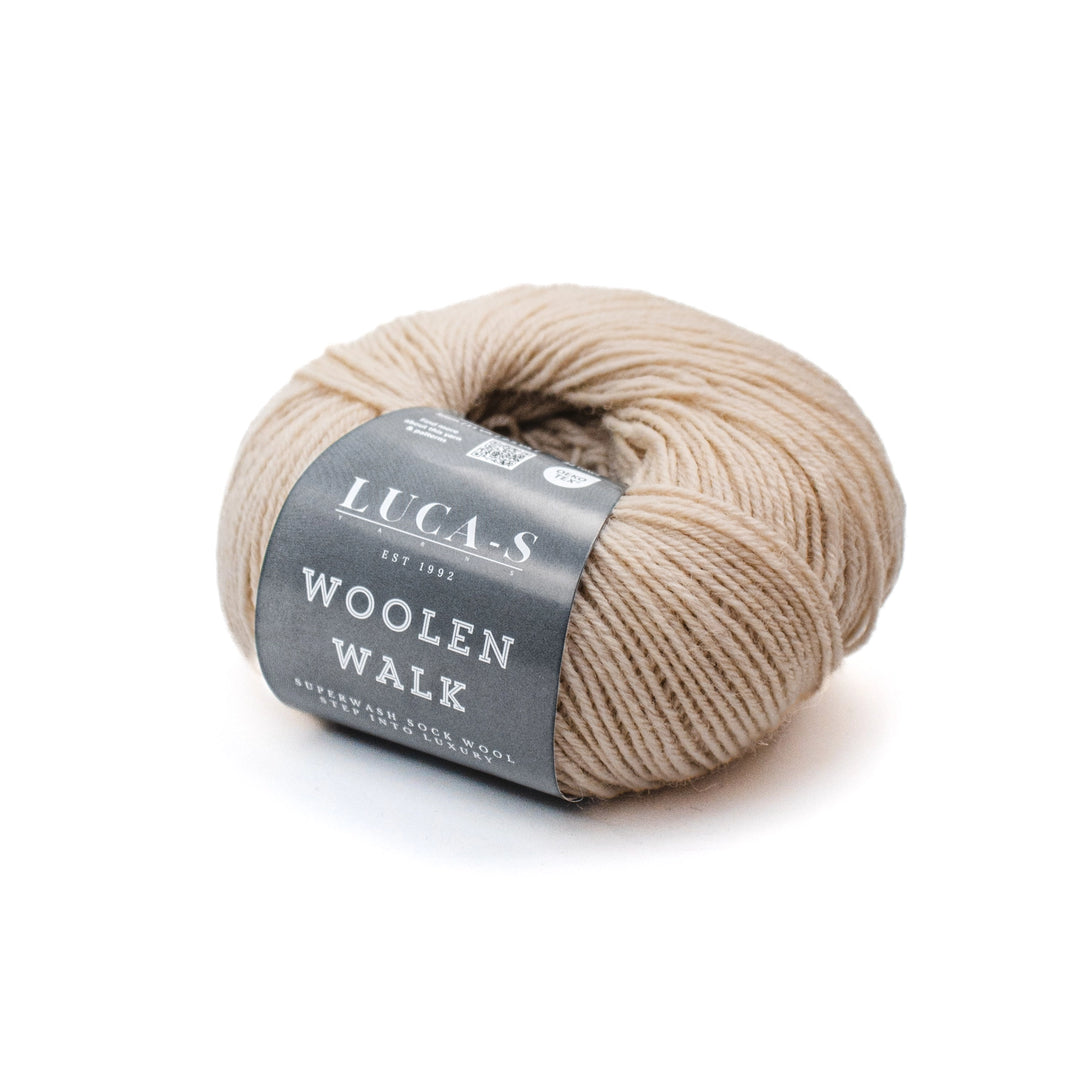 Ball of beige yarn with a gray label on a white background