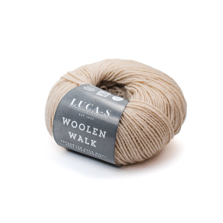 Ball of beige yarn with a gray label on a white background