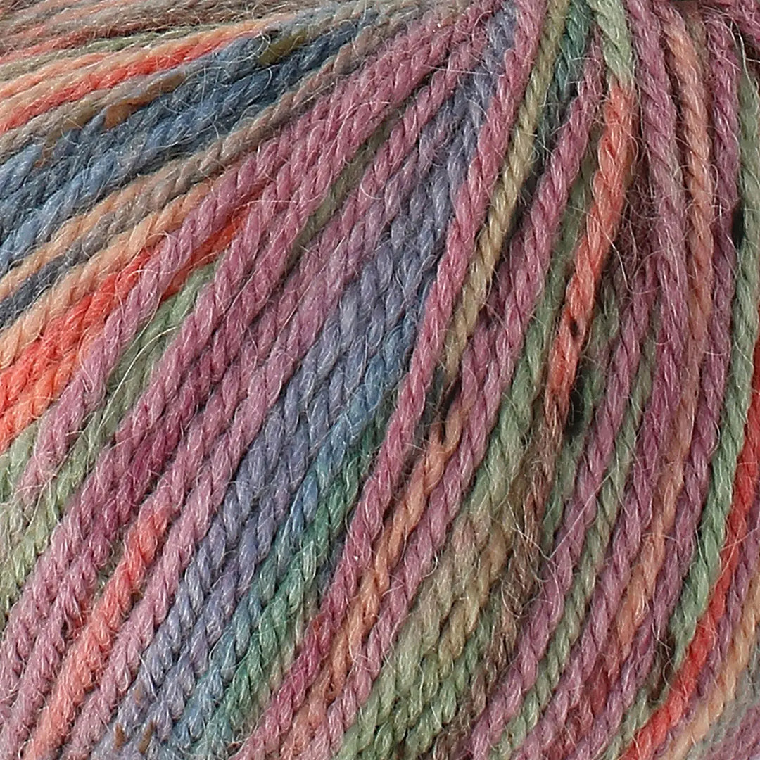 Close-up of multicolored yarn with shades of pink, green, and orange.