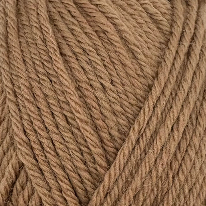A close-up of thick, twisted yarn in a warm tan or light brown color, filling the entire frame.