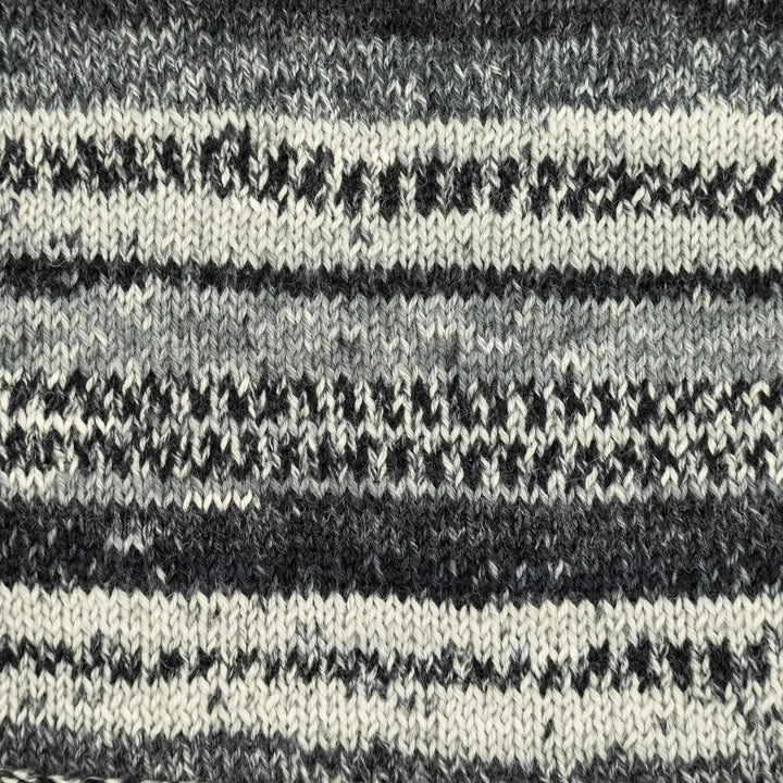 Close-up of a knitted fabric with black and white stripes.
