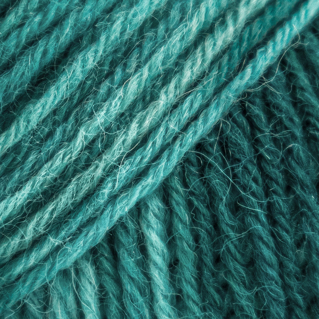 Close-up of teal yarn with a textured surface