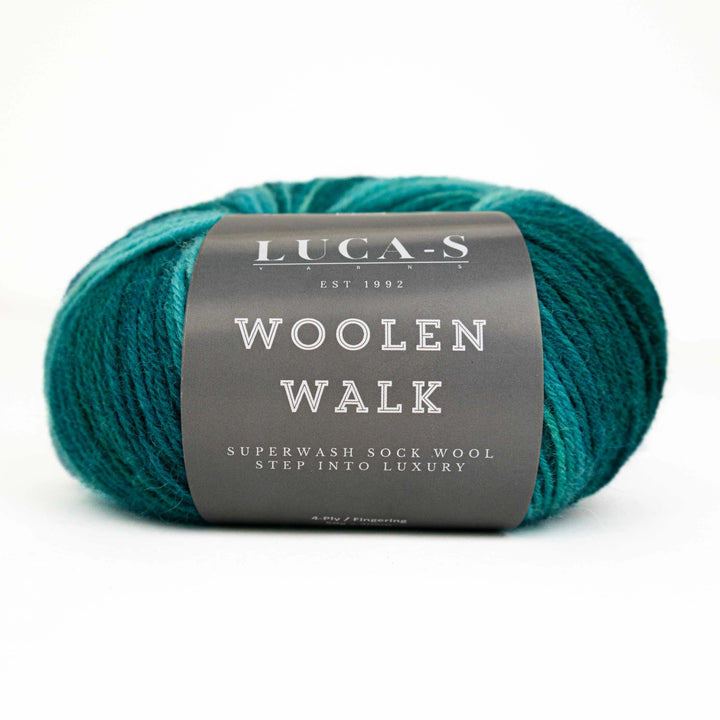 Teal skein of yarn with a gray label on a white background