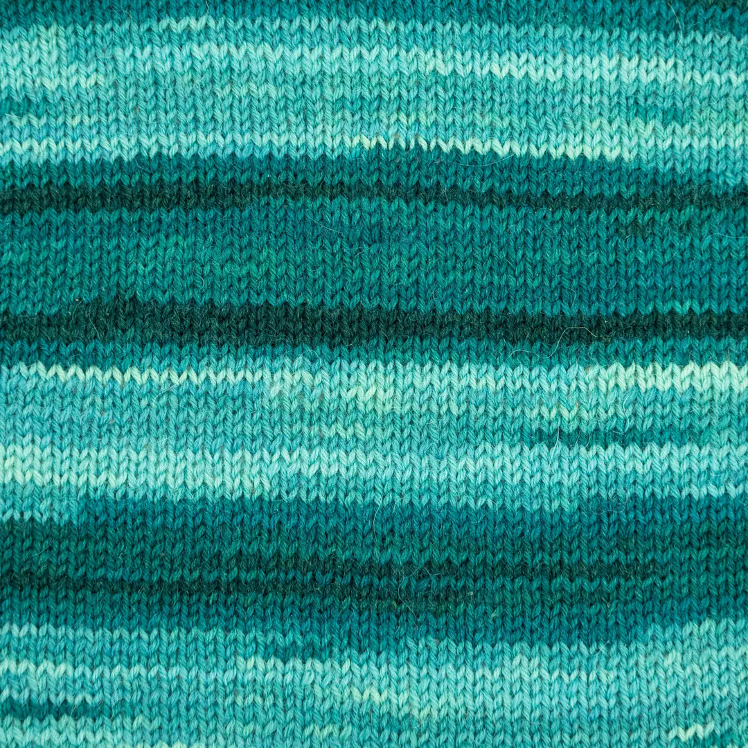 Close-up of teal and green striped fabric texture