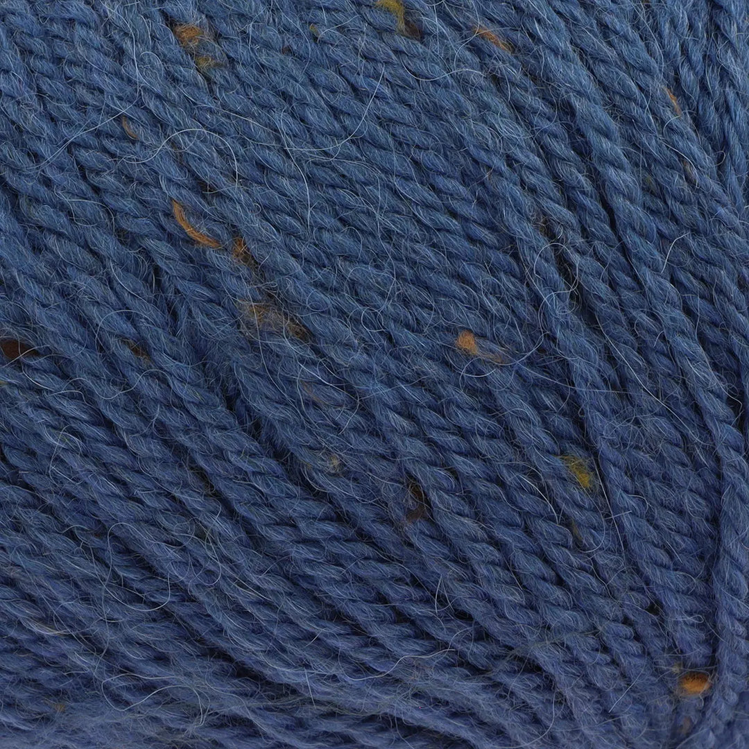 Close-up of blue yarn with brown specks