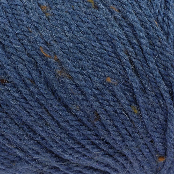 Close-up of blue yarn with brown specks