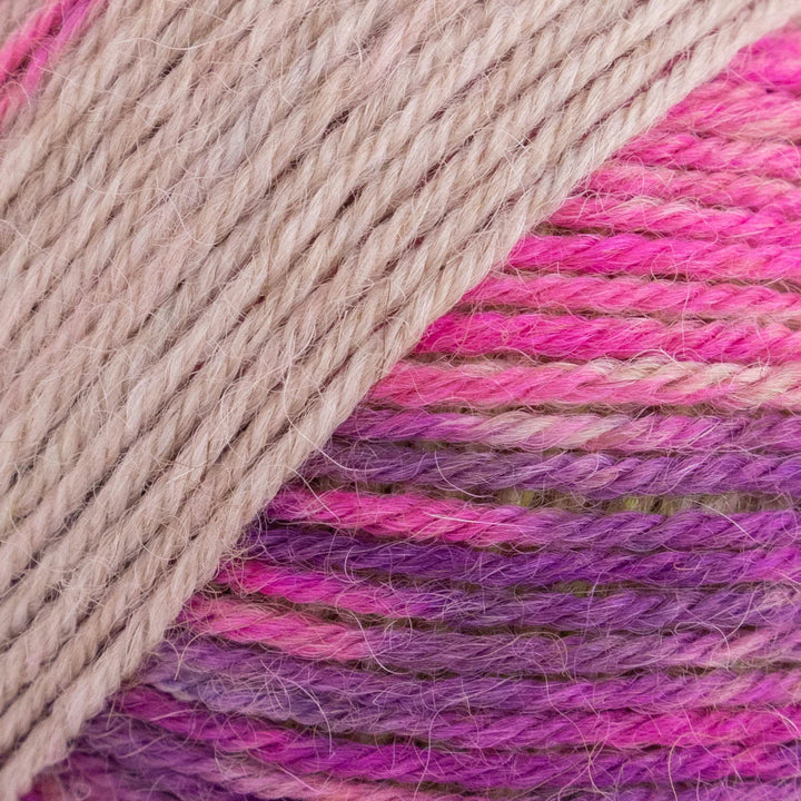 Close-up of pink and purple yarn with beige thread