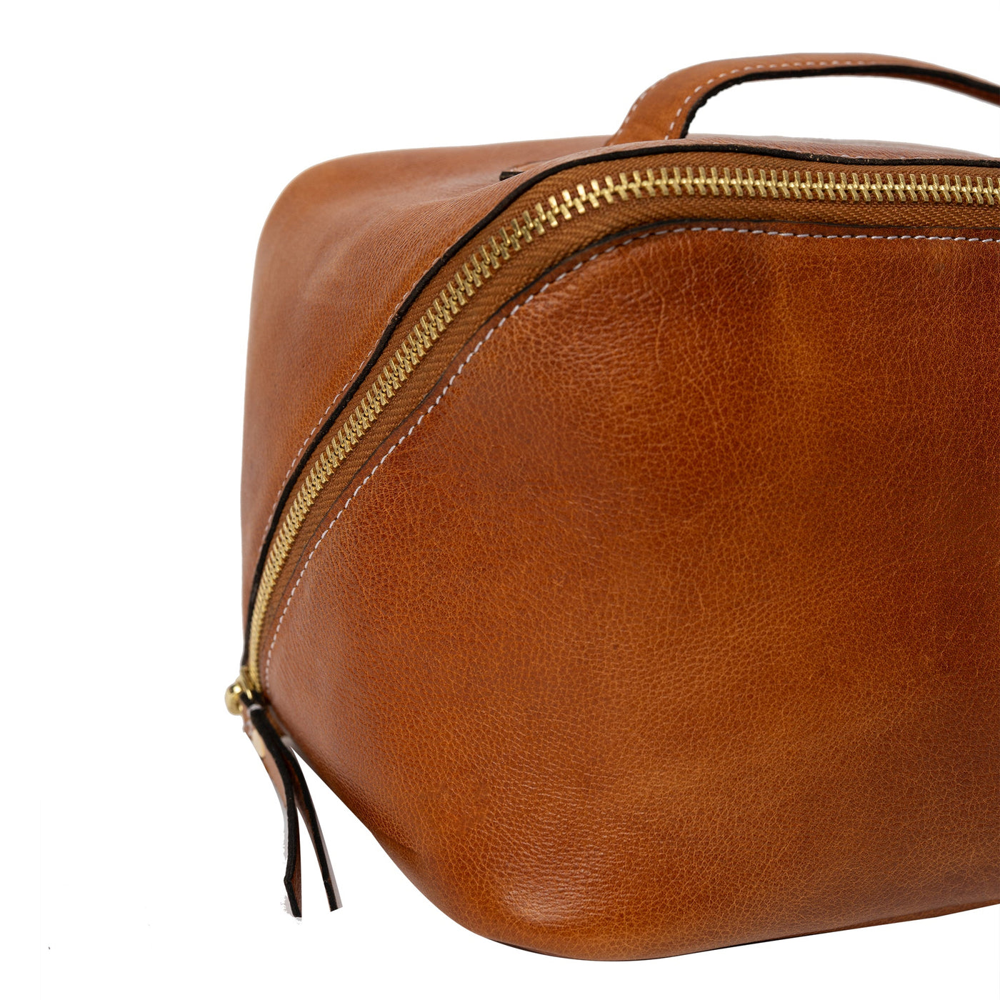 Brown leather toiletry bag with gold zipper on a white background