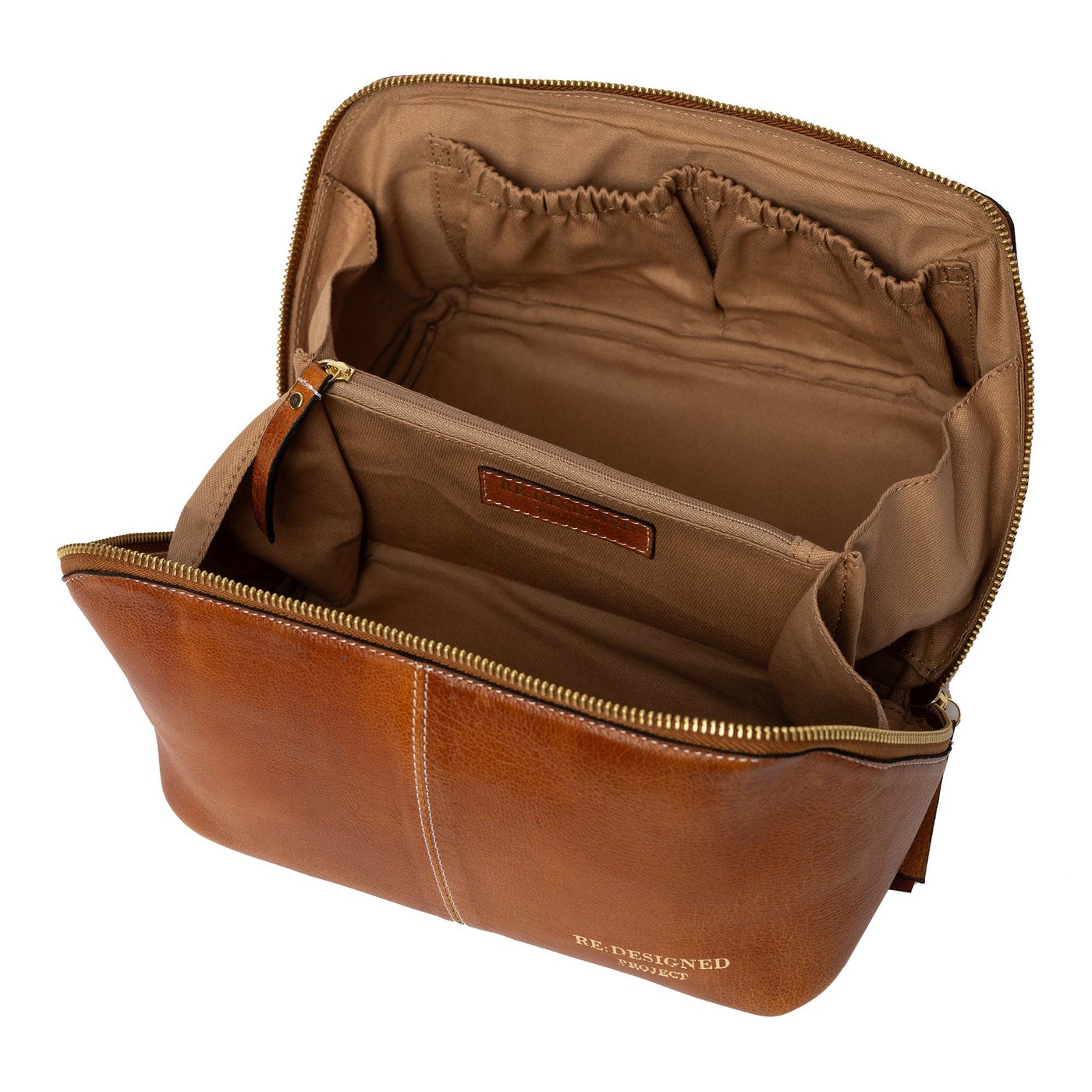 Brown leather toiletry bag with open compartment on a white background