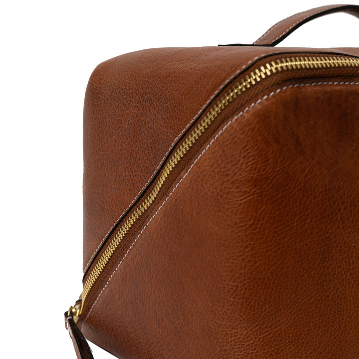 Brown leather bag with gold zipper on a white background