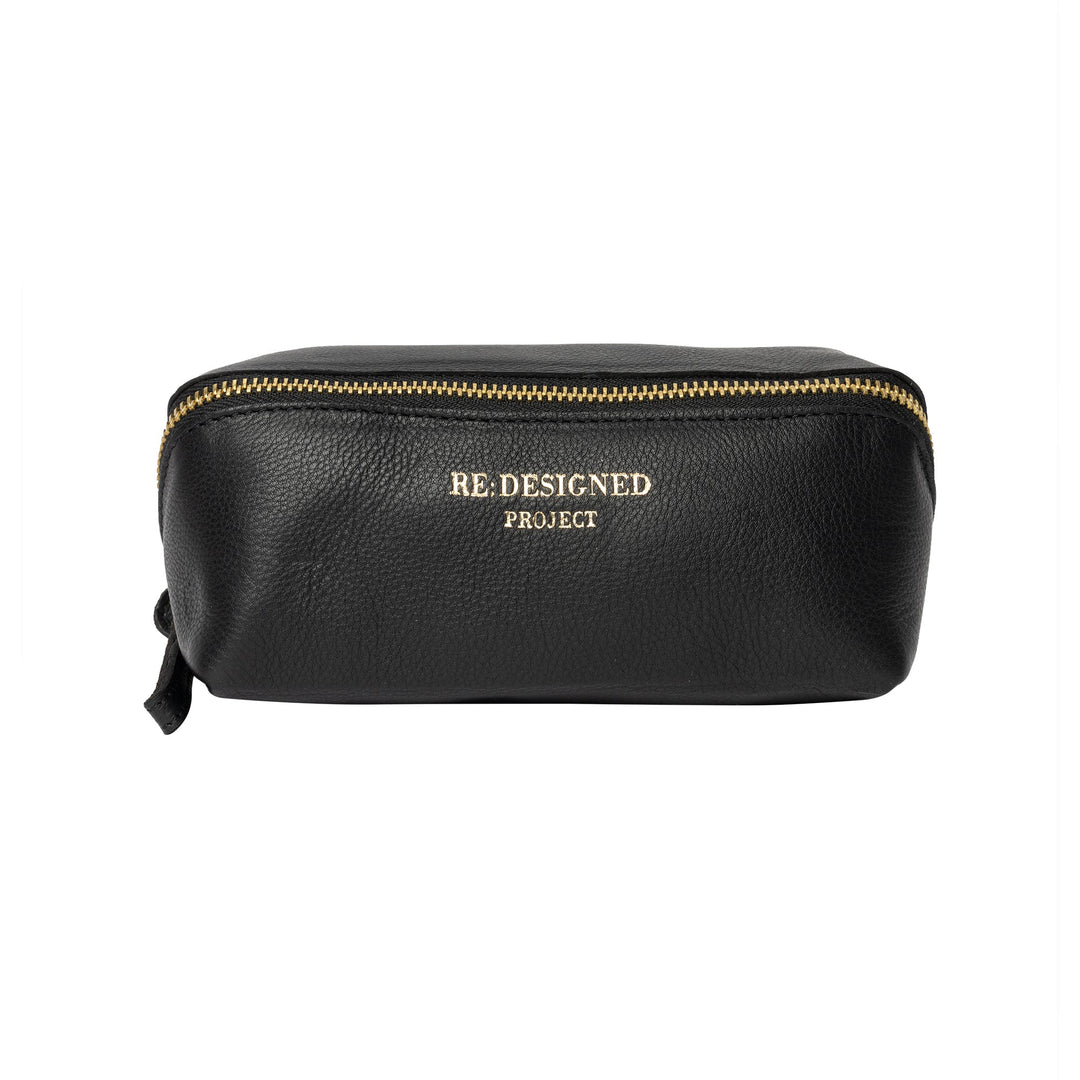 Black leather pouch with gold zipper and 'RE DESIGNED PROJECT' branding on a white background