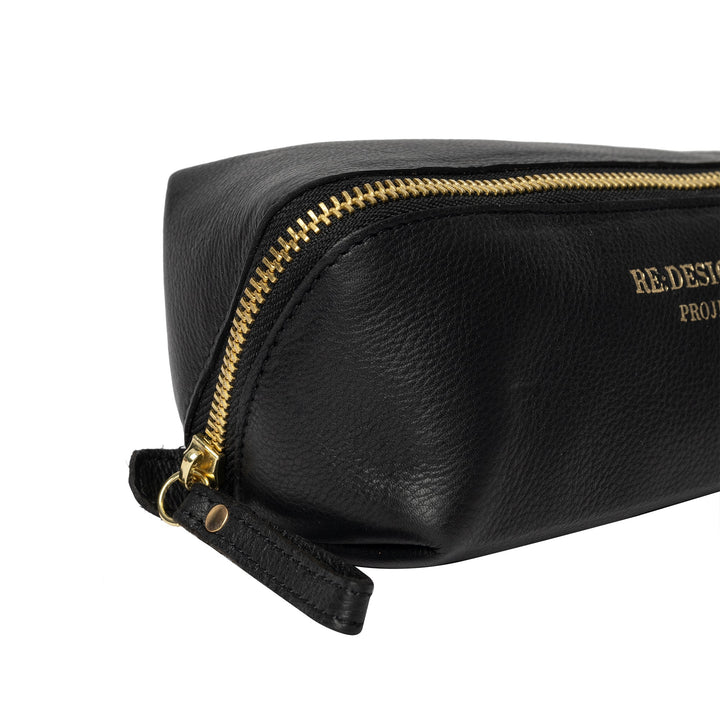 Black leather pouch with gold zipper on a white background