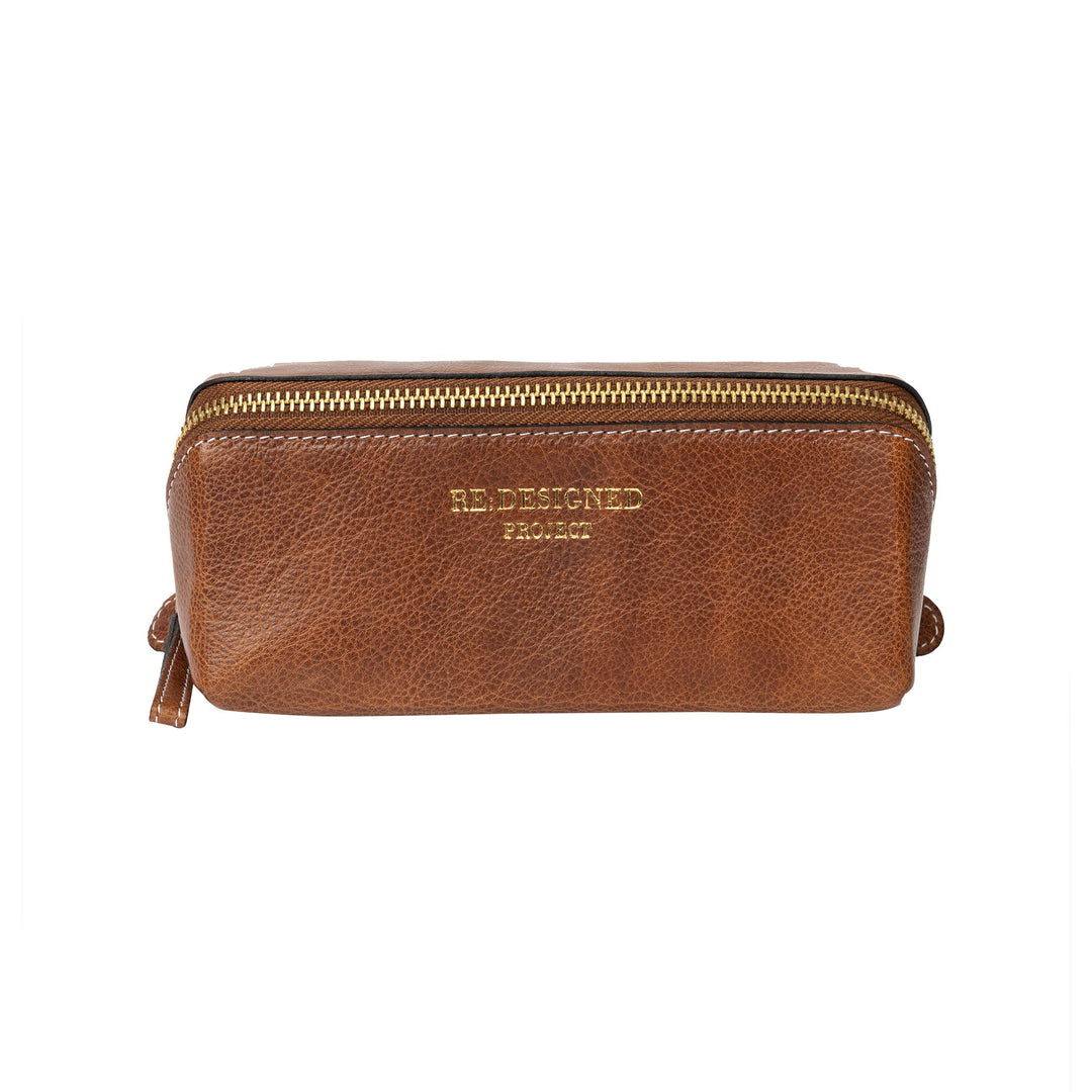 Brown leather pouch with gold zipper on a white background