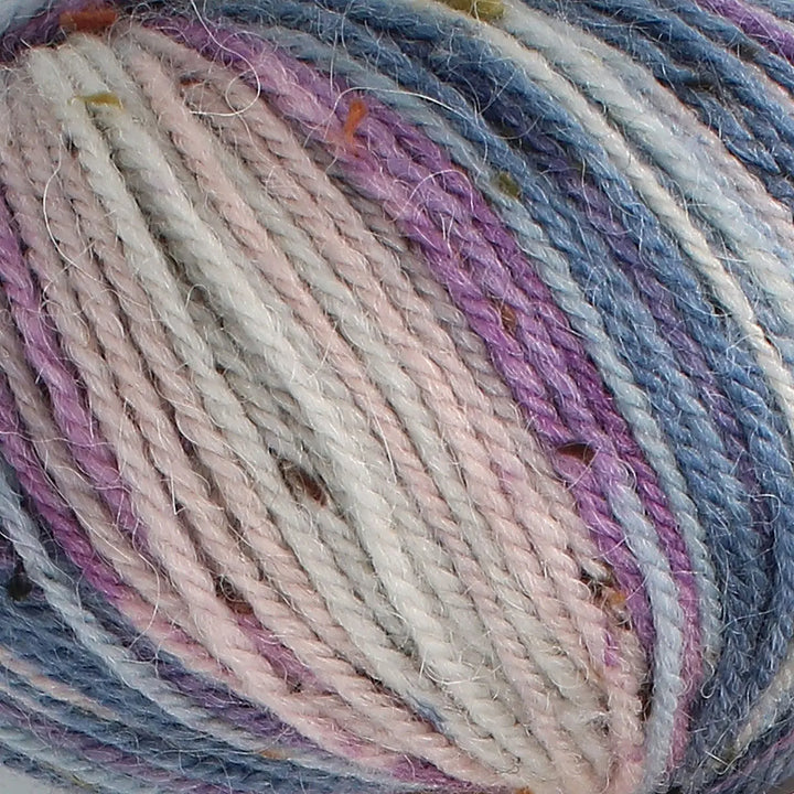 Close-up of multicolored yarn with shades of blue, purple, and beige.