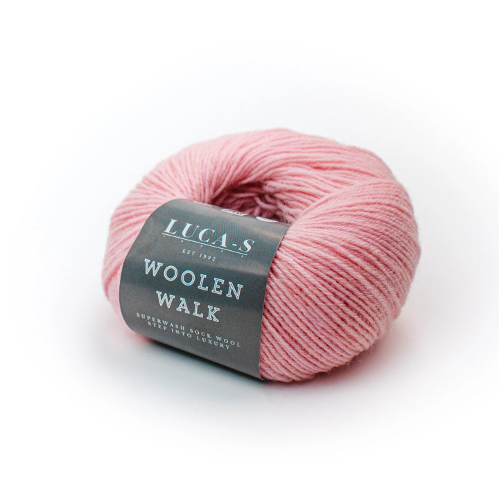 Pink skein of yarn with a label on a white background