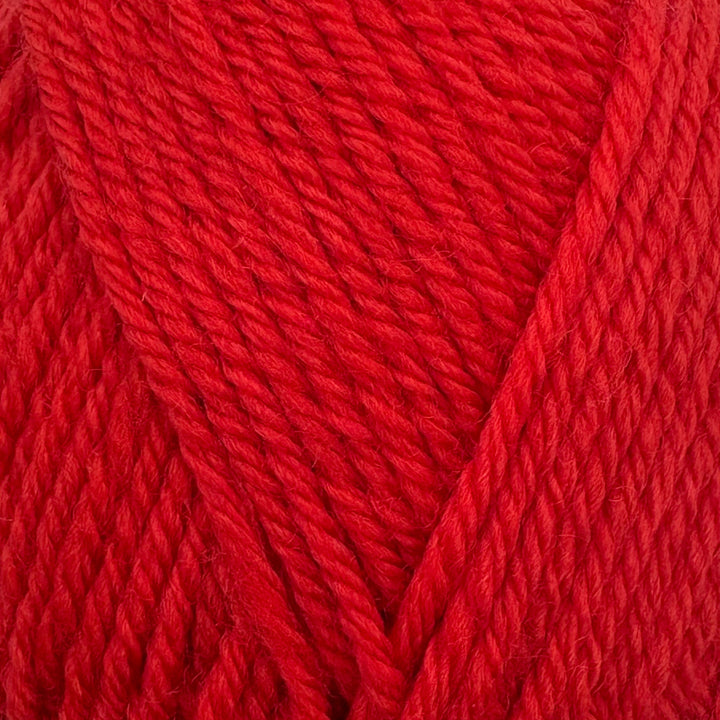 A close-up of textured yarn in a bright red colour, showing the twisted plies and soft fibers.