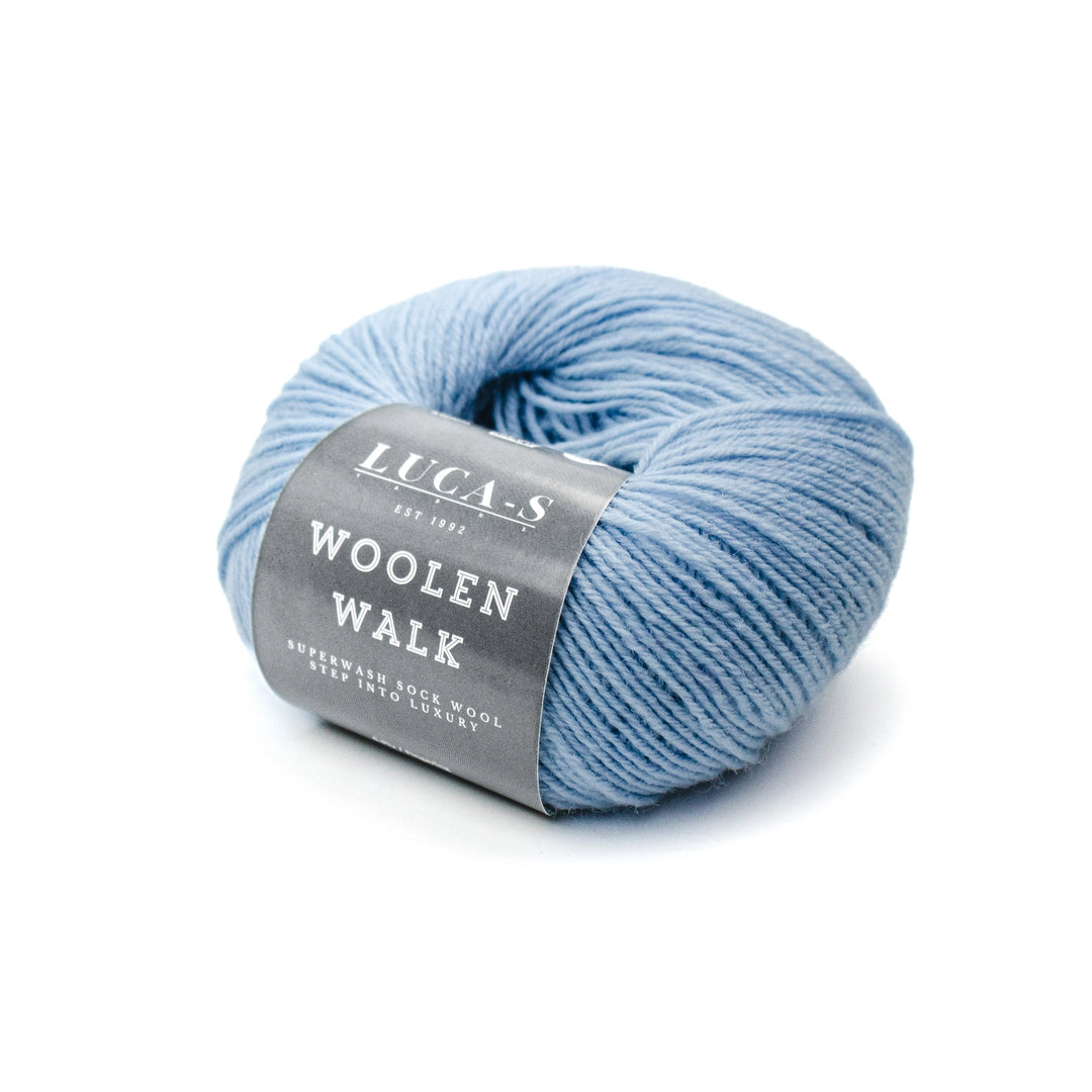 Ball of blue yarn with a label on a white background