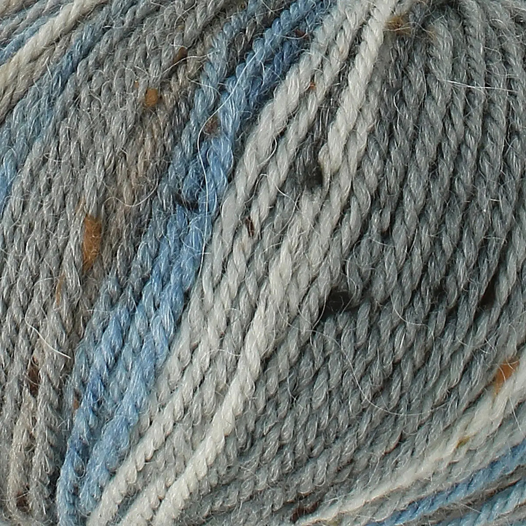 Close-up of multicolored yarn with shades of blue, gray, and beige.