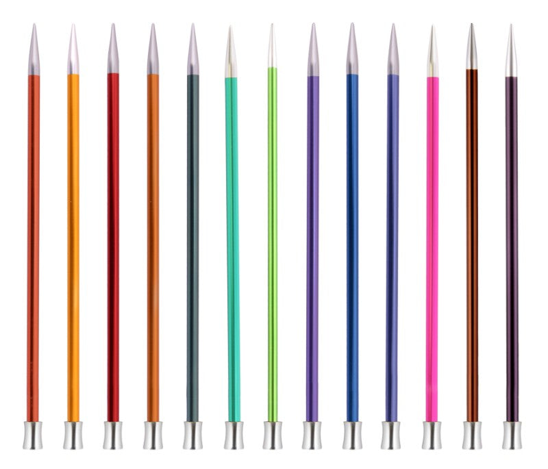 Set of colorful knitting needles with silver tips on a white background