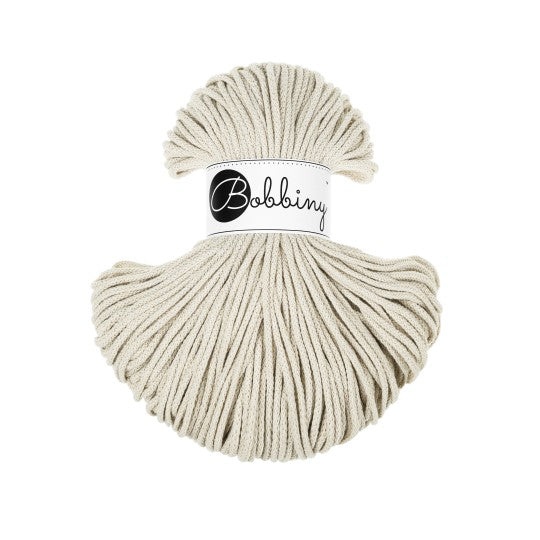 Ball of beige yarn with &
