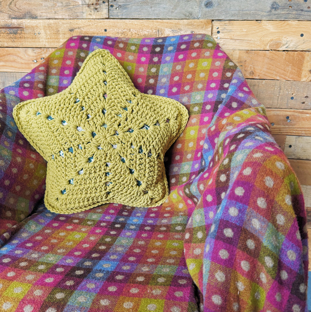 crocheted star cushion in chair