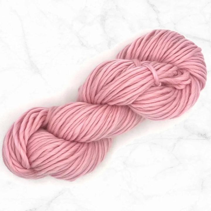 pink candyfloss yarn skein on a marble background