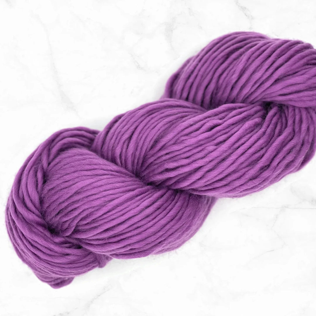 purple skein of yarn on a marble background