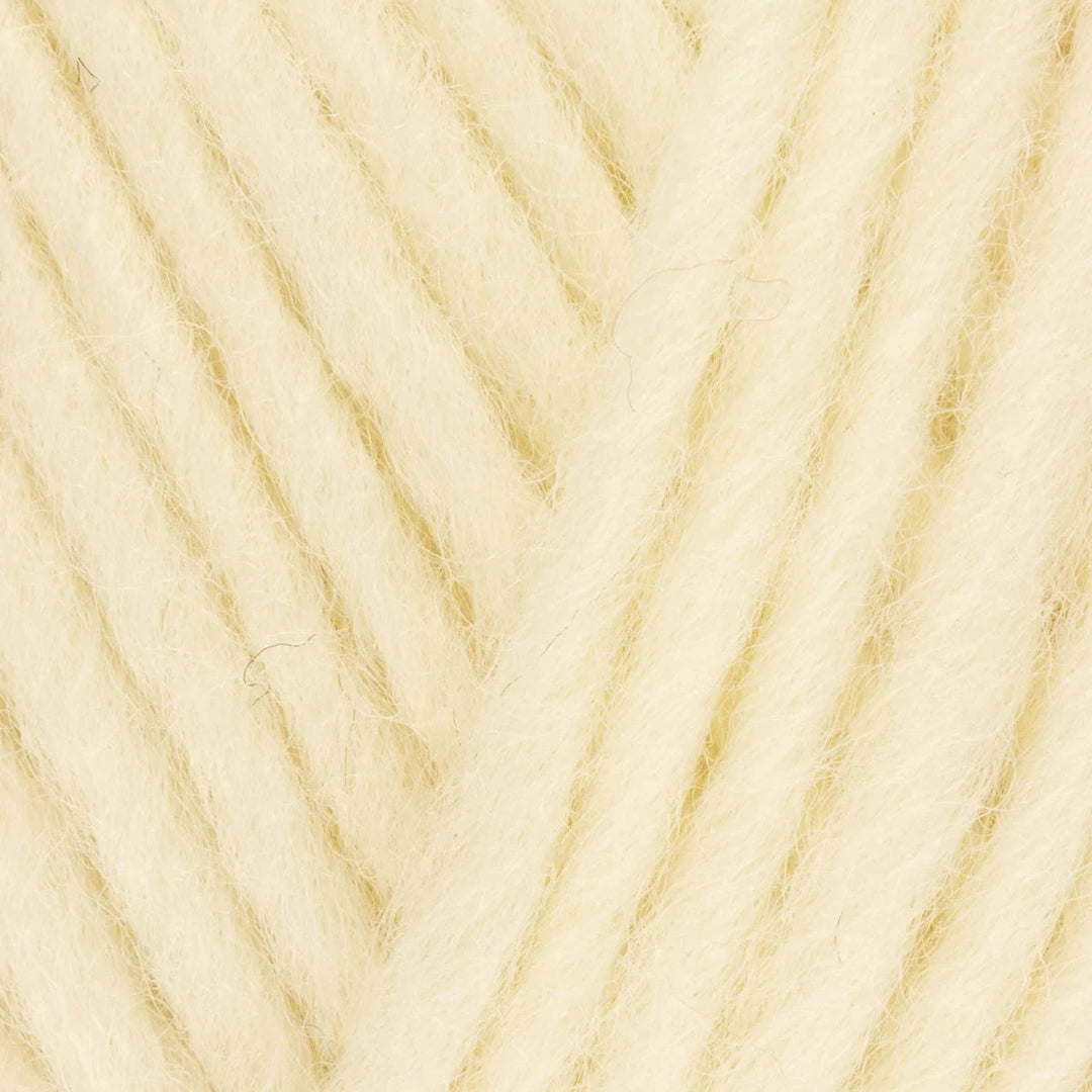 Close-up of beige yarn with a textured pattern