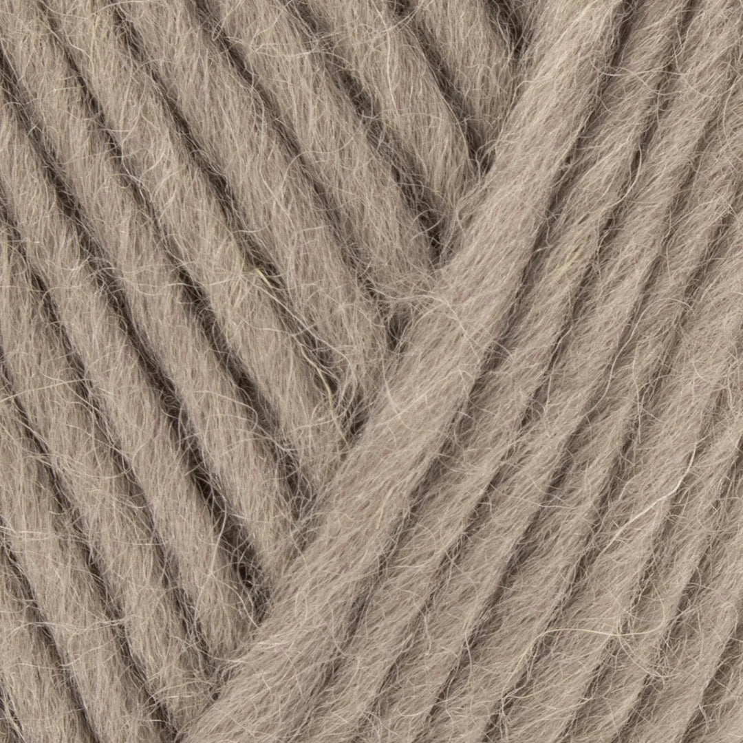 Close-up of beige yarn with visible texture